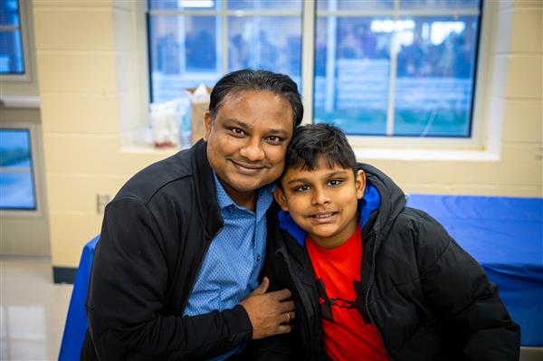 dad and son smiling at table